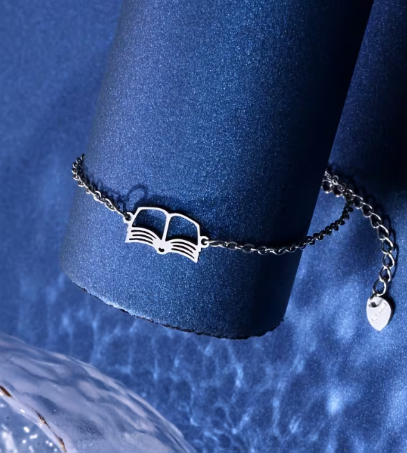Silver bracelet with a unique design on a blue cushion