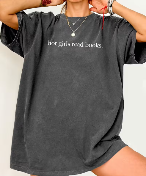 Person wearing a gray t-shirt with 'hot girls read books' text on a plain background