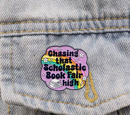 Chasing That Scholastic Book Fair High Enamel Pin
