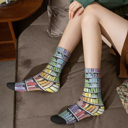 Person wearing colorful book-themed socks on a brown couch.